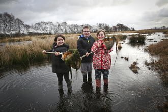 Children use nets in water